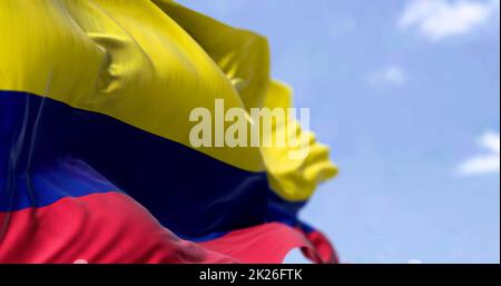 Detaillierte Nahaufnahme der Nationalflagge Kolumbiens, die an einem klaren Tag im Wind winkt Stockfoto