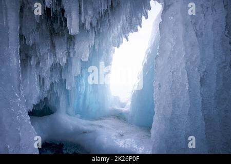 Eine Eishöhle lockt am Baikalsee, dem ältesten und tiefsten Süßwassersee der Welt, der in Sibirien liegt. Stockfoto