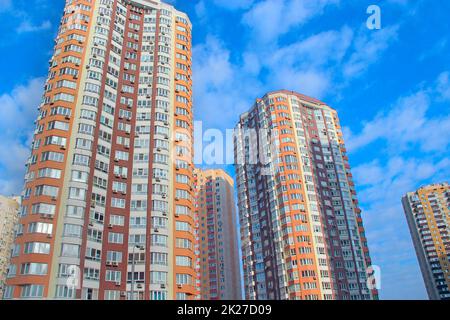 Hoher moderner Wolkenkratzer und blauer Himmel. Blick auf mehrstöckige Wohngebäude Stockfoto