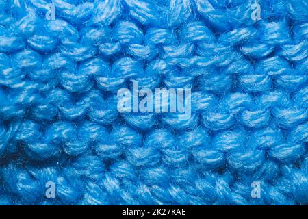 Nahaufnahme des gestrickten Hintergrunds. Blauer Wollstoff Stockfoto