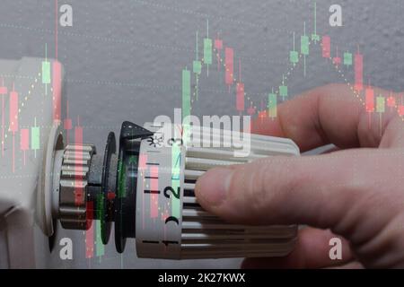 Die Energiepreise steigen und der Energieverbrauch wird durch Einschalten eines Thermostatreglers mit einem Diagramm erhöht Stockfoto