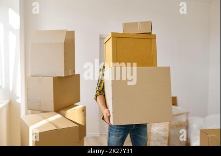 Mann, der viele Pappkartons im Stapel trägt Stockfoto