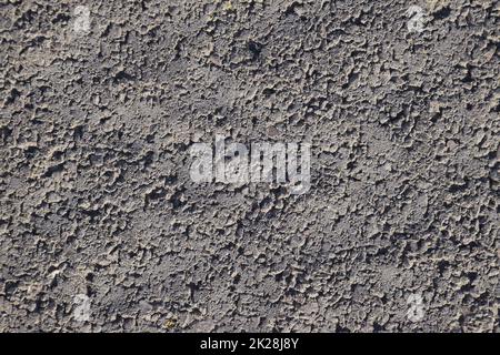 Die Textur von Pflasterplatten wird näher betrachtet. Nahaufnahme von Pflasterplatten. Hintergrund von Gefrierzement Stockfoto