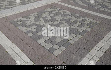 Finden Sie die Pflasterplatten im Quadrat heraus. Hintergrund von Pflasterplatten. Textur von Steinprodukten Stockfoto