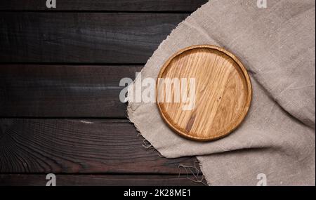 Leere runde braune Holzplatte auf Tisch, Draufsicht Stockfoto