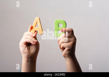 Hände mit zwei schwammigen Buchstaben ab Stockfoto