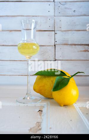 Ein Glas Limoncello-Likör auf altem Holz Stockfoto