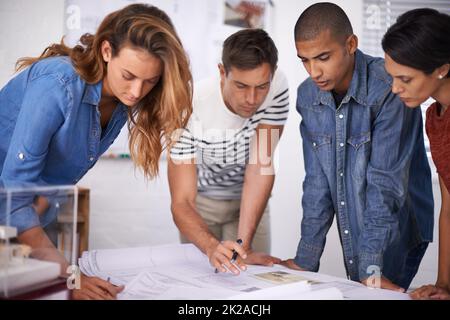 Das Design kommt wirklich zusammen. Eine Gruppe junger Designer arbeitet in einem Büro zusammen. Stockfoto