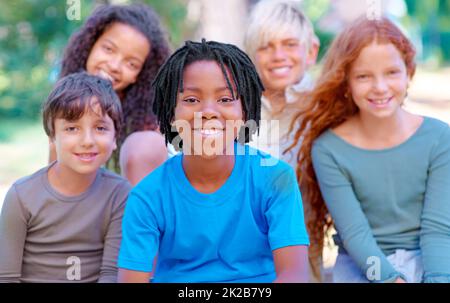 Sie sind unsere Zukunft. Eine Gruppe von Kindern lächelt im Freien an der Kamera. Stockfoto