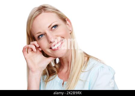 Überdenken Eine schöne Frau, die nachdenklich und lächelnd wegschaut - isoliert. Stockfoto