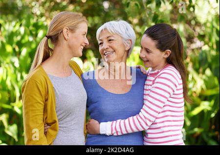 Bindung mit Angehörigen. Aufnahme von drei Generationen von Familienfrauen, die im Freien stehen. Stockfoto