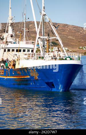 Kommen Sie mit einem reichen Haul. Aufnahme eines Fischtrawlers, der in den Hafen zurückkehrt. Stockfoto