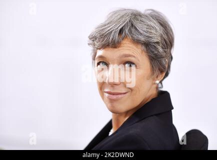 Es ist gut, der Chef zu sein. Porträt einer reifen Geschäftsfrau, die drinnen sitzt. Stockfoto