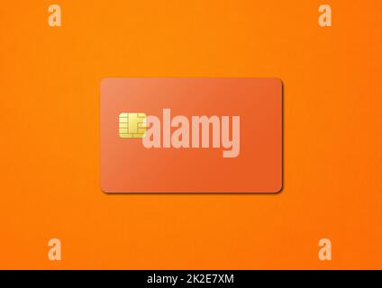 Orangefarbene Kreditkarte auf farbigem Hintergrund Stockfoto