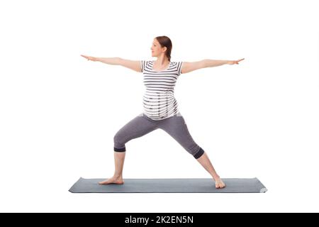 Schwangere beim Yoga Asana Virabhadrasana 2 Stockfoto