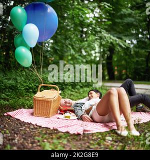 Romantischer Wald, rendevous. Ein junges Paar, das sich bei einem Picknick im Wald entspannt. Stockfoto