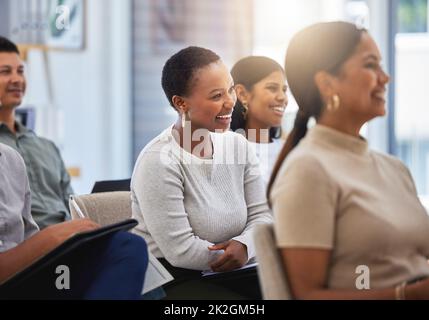 Der Weg zum Erfolg. Aufnahme einer Gruppe von Mitarbeitern, die während eines Meetings bei der Arbeit in einem modernen Büro lachen. Stockfoto