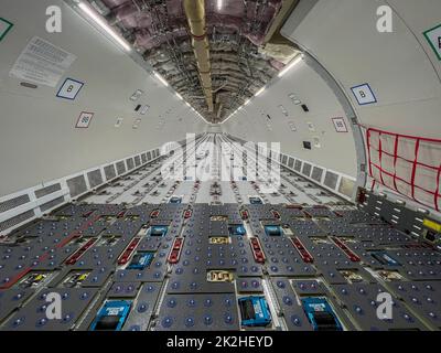 Cargo Airplane - view inside the main deck cargo compartment on a freshly converted wide-body freighter aircraft Stock Photo