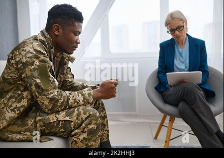 Soldat und Psychotherapeut während der Konsultation Stockfoto