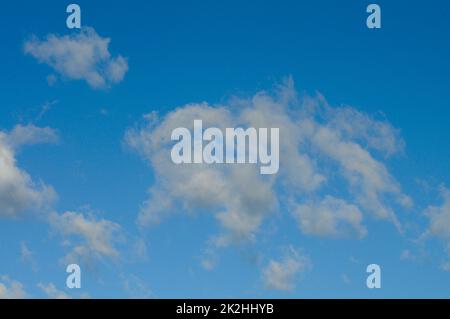 Ein strahlend blauer Himmel mit weichen weißen Wolken Stockfoto