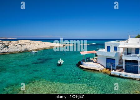 Griechenland Insel Milos. Kleiner Hafen mit Fischerbooten im Wasser, weiß getünchtes Haus. Mitakas Dorf Stockfoto