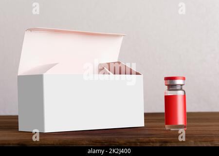 Angebrochene Fläschchen Box mit einem Fläschchen vorne auf Holzbretter Modellserie Stockfoto