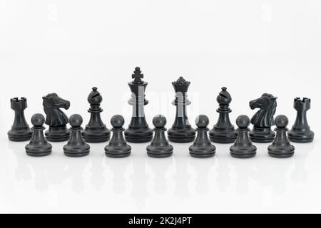 Schwarze Schachfiguren auf weißem Hintergrund Stockfoto