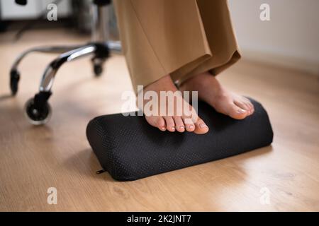 Arbeiter, Der Fußstützen Verwendet, Um Rückenschmerzen Zu Reduzieren Stockfoto