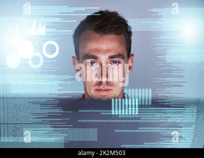 HES der Master der Metadaten. Aufnahme eines jungen Programmierers, der an seinem Computer mit einer Überlagerung von Computergrafiken arbeitet. Stockfoto