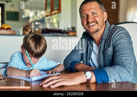 HES neugierig auf alles von A-z. Aufnahme eines Vaters, der seinem Sohn bei seinen Hausaufgaben hilft. Stockfoto