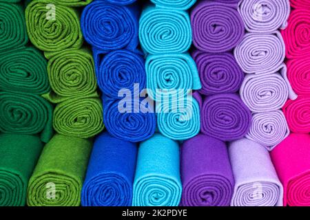 Muster von Stoffen und Stoffen in verschiedenen Farben, die auf einem Stoffmarkt zu finden sind. Stockfoto