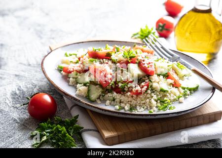 Traditionelle orientalische Salattabulei. Salat aus Cous Cous mit Gemüse. Tabbouleh mit Bulgur Stockfoto