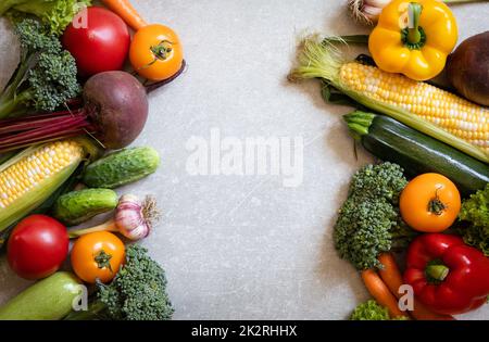 Gesunde Lebensmittel Hintergrund. Gesundes vegetarisches Essen. Frische rohe Salatzutaten, Gemüse Tomaten Gurken Salat Pfeffer. Kopierbereich, selektiver Fokus Stockfoto