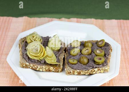 Getreidekeimbrot, Hummus aus schwarzen Bohnen und Gemüsesnack Stockfoto