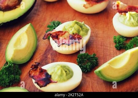 Frühstück - deviled Eiern mit Avocado und knackig Schinken Stockfoto