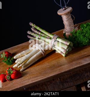 Grüner und weißer Spargel auf dem Tisch Stockfoto