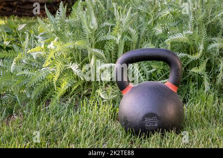 kettlebell on Gras - Fitness im Garten Stockfoto