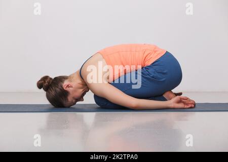 Schön sportlich fit Yogi Mädchen Praktiken Yoga Asana balasana Stockfoto