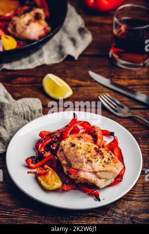 Gebackene Hähnchenschenkel mit roten Paprika und Zitrone Stockfoto