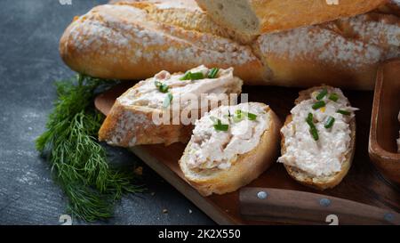 Französisches Baguette mit oder Sandwiches mit geräuchertem Lachs und Pastete oder Mousse mit Frischkäse Stockfoto