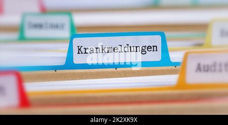Ordner mit einer Registerkarte mit der Aufschrift Krankmeldungen in deutsch Stockfoto