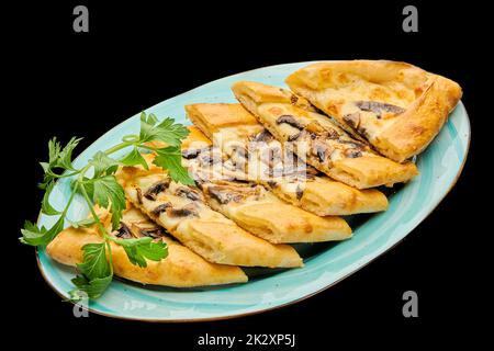 türkische Pizza Pide mit Käse und Fleisch auf einem schwarzen isolierten Hintergrund Stockfoto