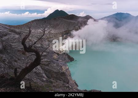 Ein Blick aus der Vogelperspektive auf einen blauen Säuresee mit Schwefeldampf in der Nähe des Mount Ijen, Java, Indonesien Stockfoto