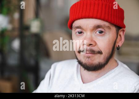 Selbstbewusster Mann mit roter Strickmütze Stockfoto