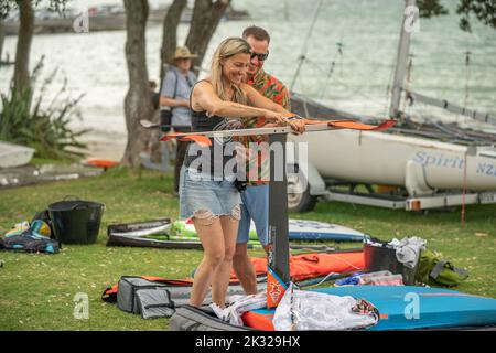 Eine junge Teilnehmerin stellt ihre Ausrüstung auf, um beim Watersports Festival in Waterbourne am nationalen neuseeländischen Windsurf-Tragflächenboot-Rennen teilzunehmen Stockfoto