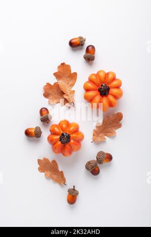 Herbstkomposition mit dekorativen Kürbissen, Eichenblättern und Eicheln Stockfoto
