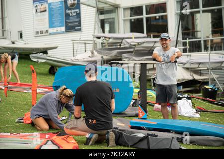 Die Teilnehmer stellen ihre Ausrüstung auf, um beim Waterbourne Watersports Festival an dem neuseeländischen nationalen Windsurf-Tragflächenboot-Rennen teilzunehmen Stockfoto