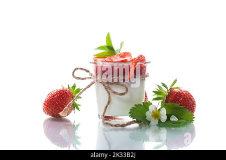 Süßer hausgemachter Joghurt mit Erdbeermarmelade und frischen Erdbeeren in einem Glas, isoliert auf weißem Hintergrund. Stockfoto