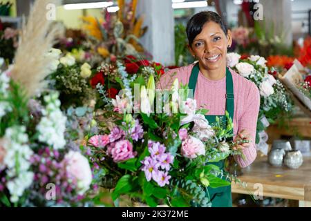 Frau Floristin in Schürze Anordnung Blumenstrauß Stockfoto