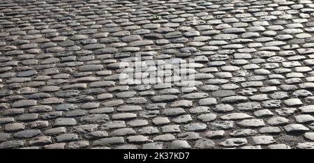 Hintergrund der Straße Bürgersteig mit vielen glatten Kieselsteinen ohne Menschen gemacht Stockfoto